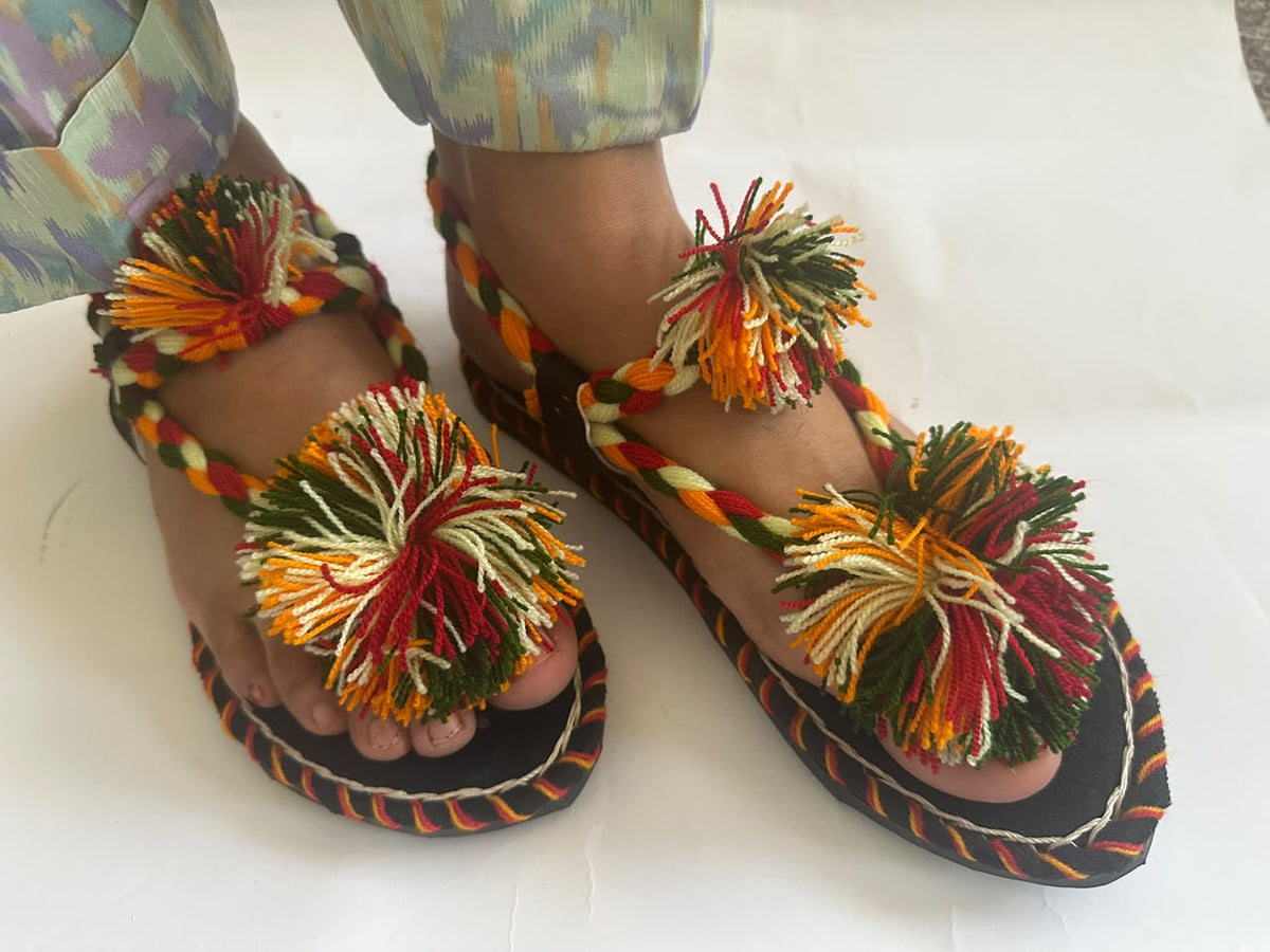 Multicolour pom pom Balochi chappals worn with shalwar – angled front view